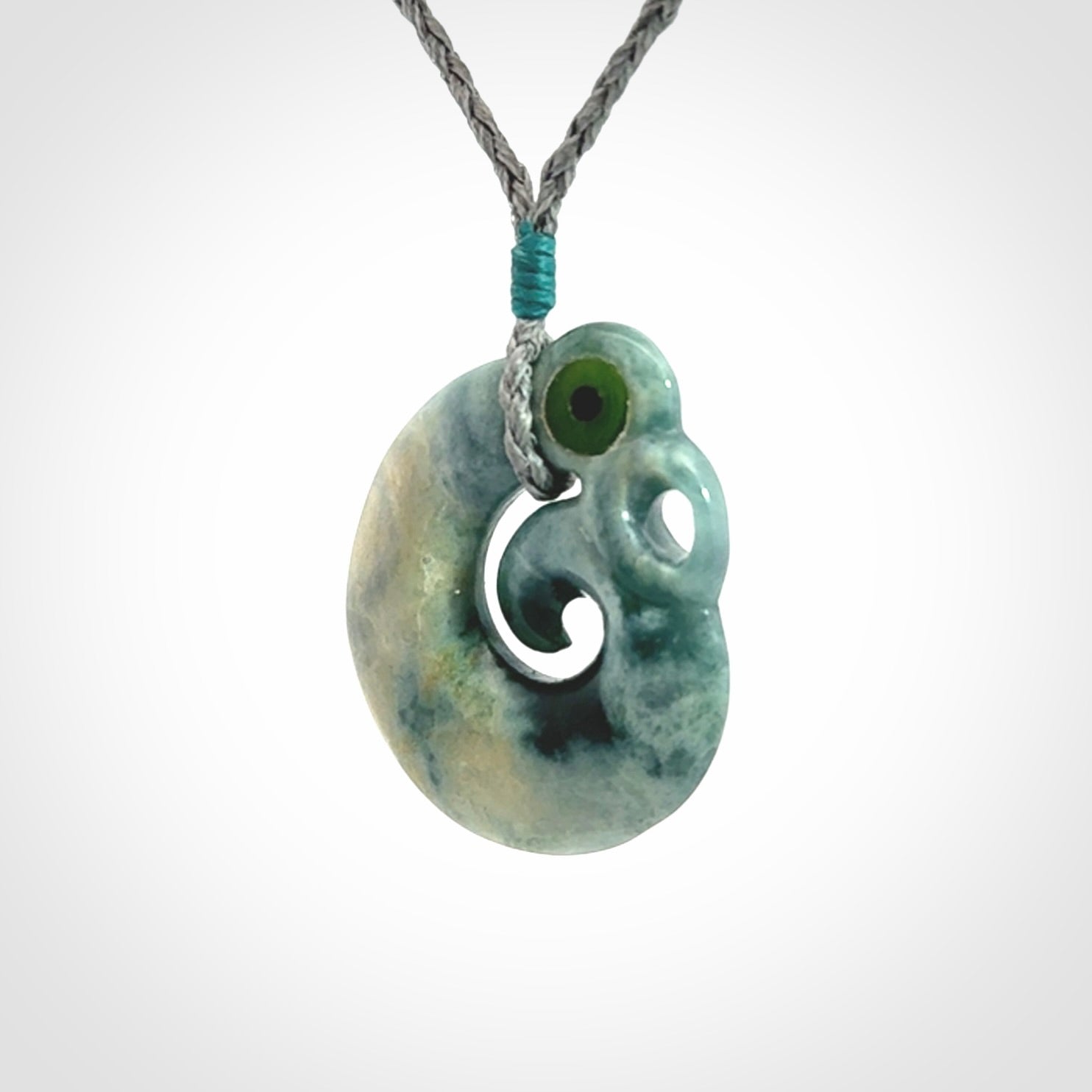 Guatemalan Jadeite Koru Manaia pendant. Made in New Zealand. Real Jade, pounamu. Real New Zealand Jade Manaia with Koru necklace with a polished finish.