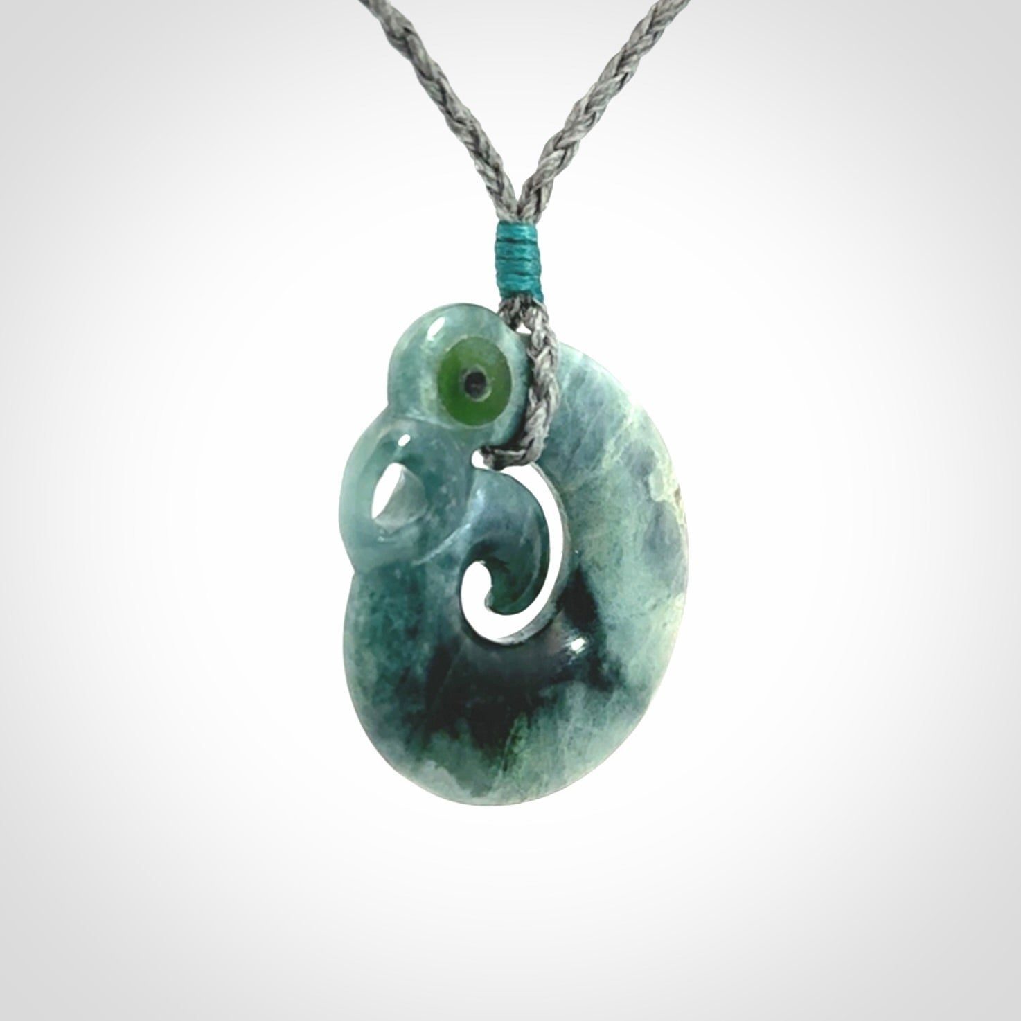 Guatemalan Jadeite Koru Manaia pendant. Made in New Zealand. Real Jade, pounamu. Real New Zealand Jade Manaia with Koru necklace with a polished finish.