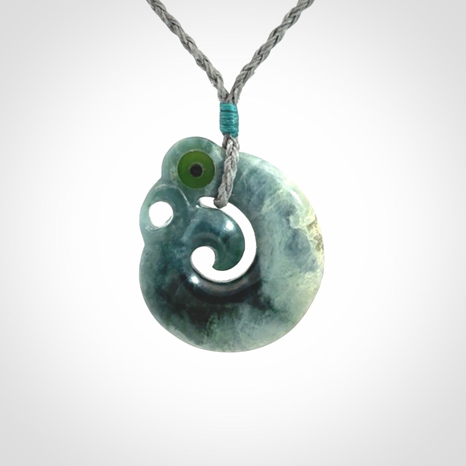 Guatemalan Jadeite Koru Manaia pendant. Made in New Zealand. Real Jade, pounamu. Real New Zealand Jade Manaia with Koru necklace with a polished finish.