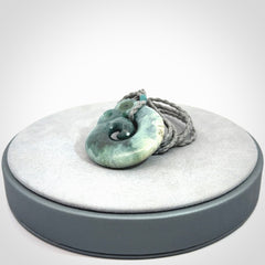 Guatemalan Jadeite Koru Manaia pendant. Made in New Zealand. Real Jade, pounamu. Real New Zealand Jade Manaia with Koru necklace with a polished finish.