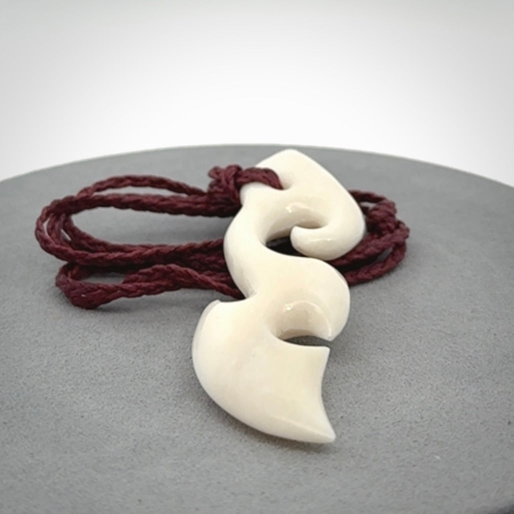 This is a wonderful, contemporary large koru from bone. Hand carved and provided with an adjustable plum cord.