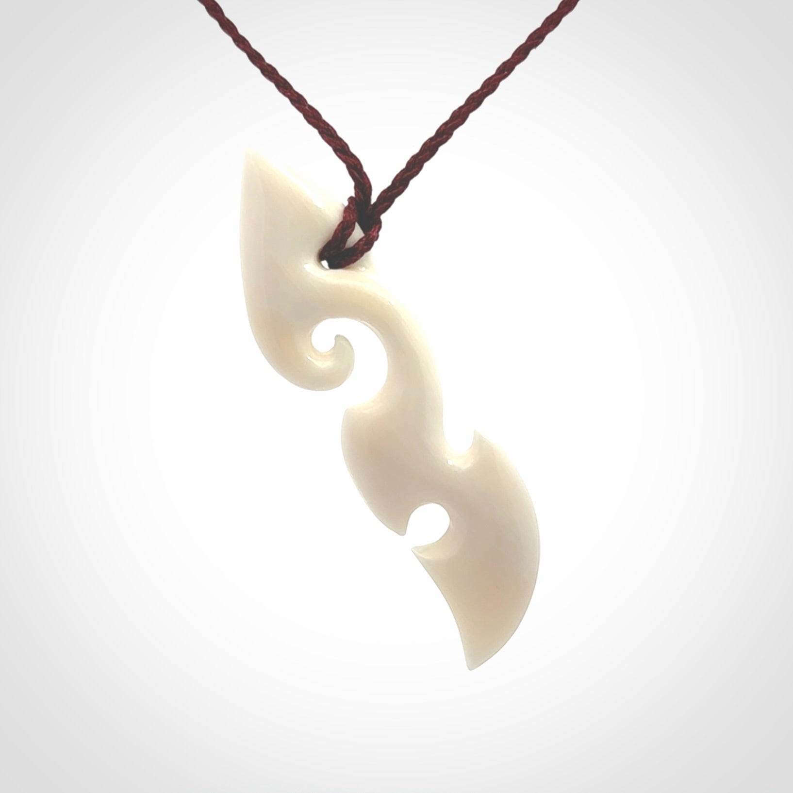 This is a wonderful, contemporary large koru from bone. Hand carved and provided with an adjustable plum cord.