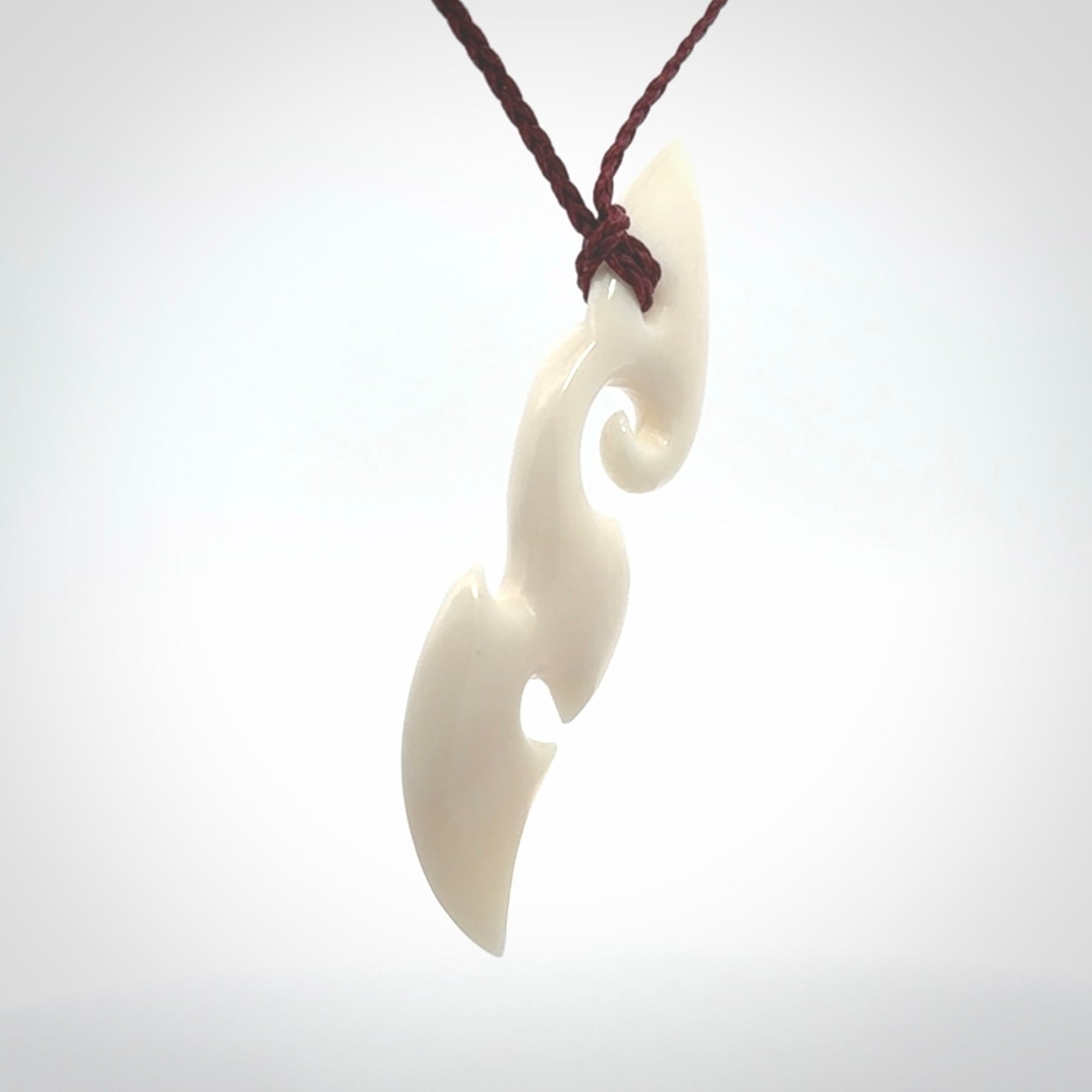This is a wonderful, contemporary large koru from bone. Hand carved and provided with an adjustable plum cord.