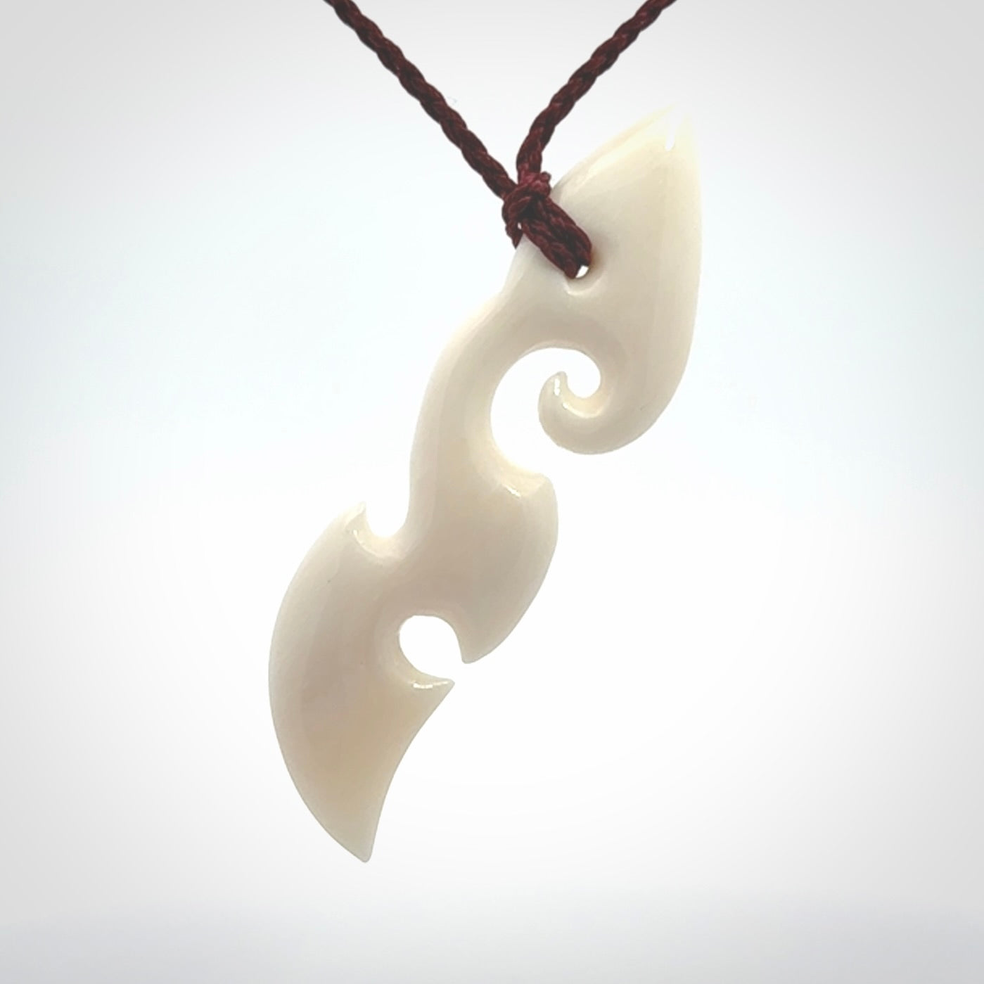 This is a wonderful, contemporary large koru from bone. Hand carved and provided with an adjustable plum cord.