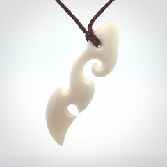 This is a wonderful, contemporary large koru from bone. Hand carved and provided with an adjustable plum cord.