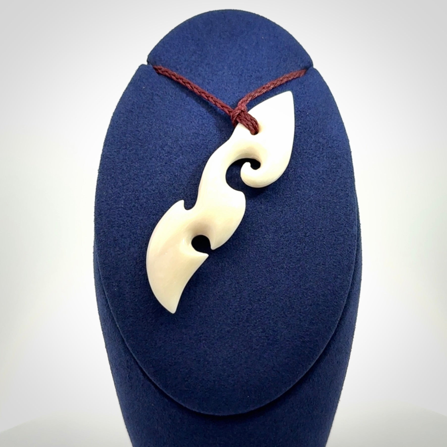 This is a wonderful, contemporary large koru from bone. Hand carved and provided with an adjustable plum cord.
