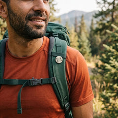 Man wearing bone pin on his backpack