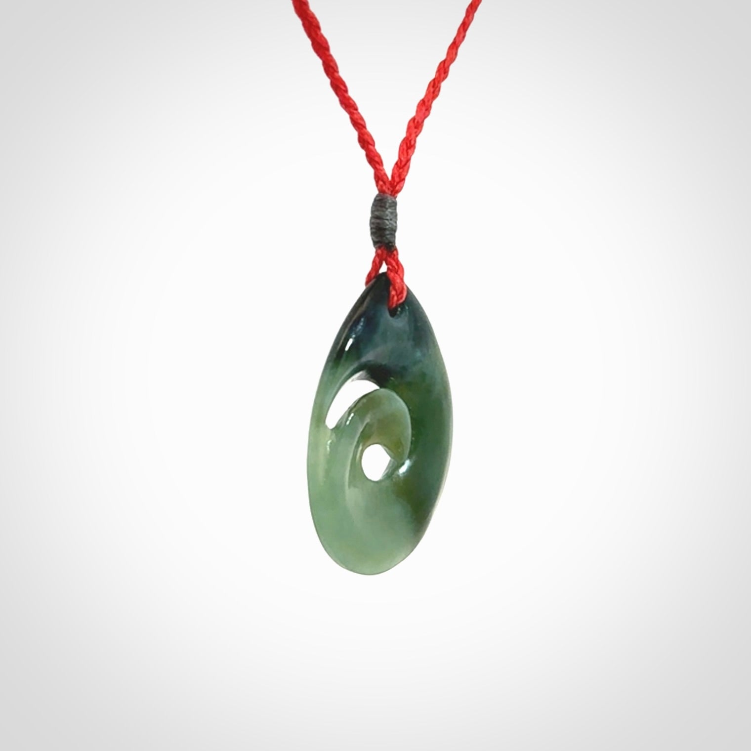 Hand carved New Zealand jade koru drop pendant. Made by NZ Pacific.Hand carved New Zealand jade koru drop pendant. Made by NZ Pacific.