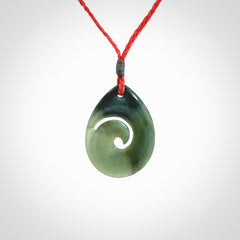 Hand carved New Zealand jade koru drop pendant. Made by NZ Pacific.Hand carved New Zealand jade koru drop pendant. Made by NZ Pacific.