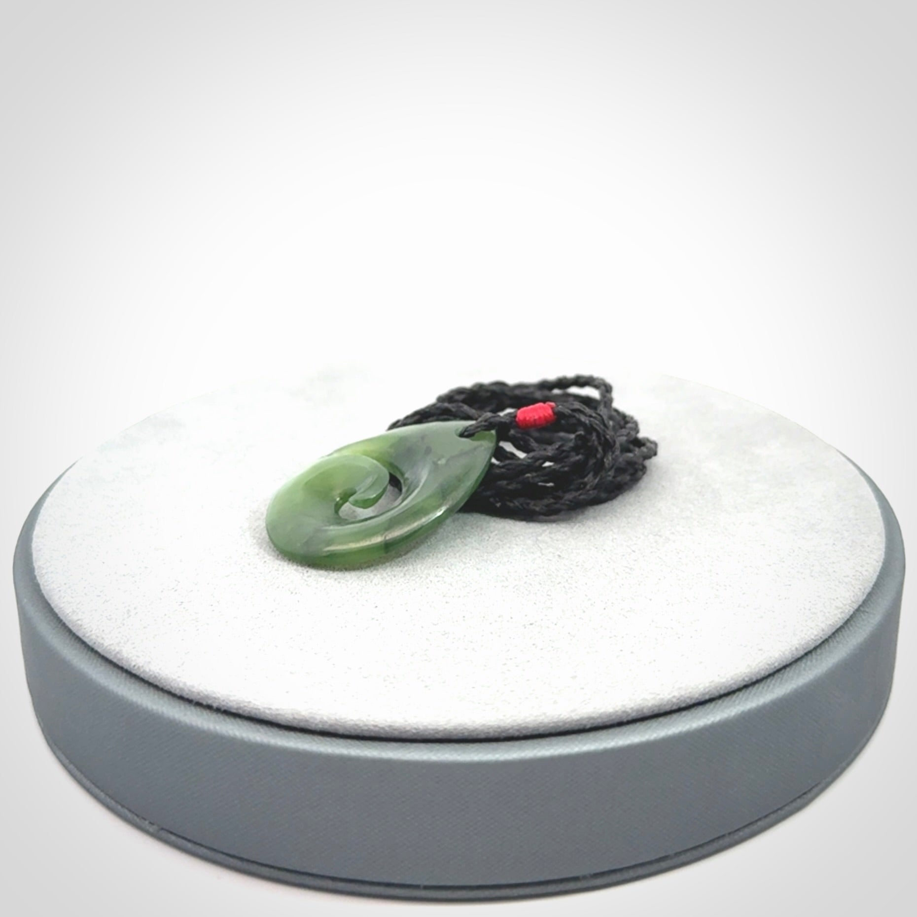 Hand carved New Zealand jade koru drop pendant. Made by NZ Pacific.Hand carved New Zealand jade koru drop pendant. Made by NZ Pacific.