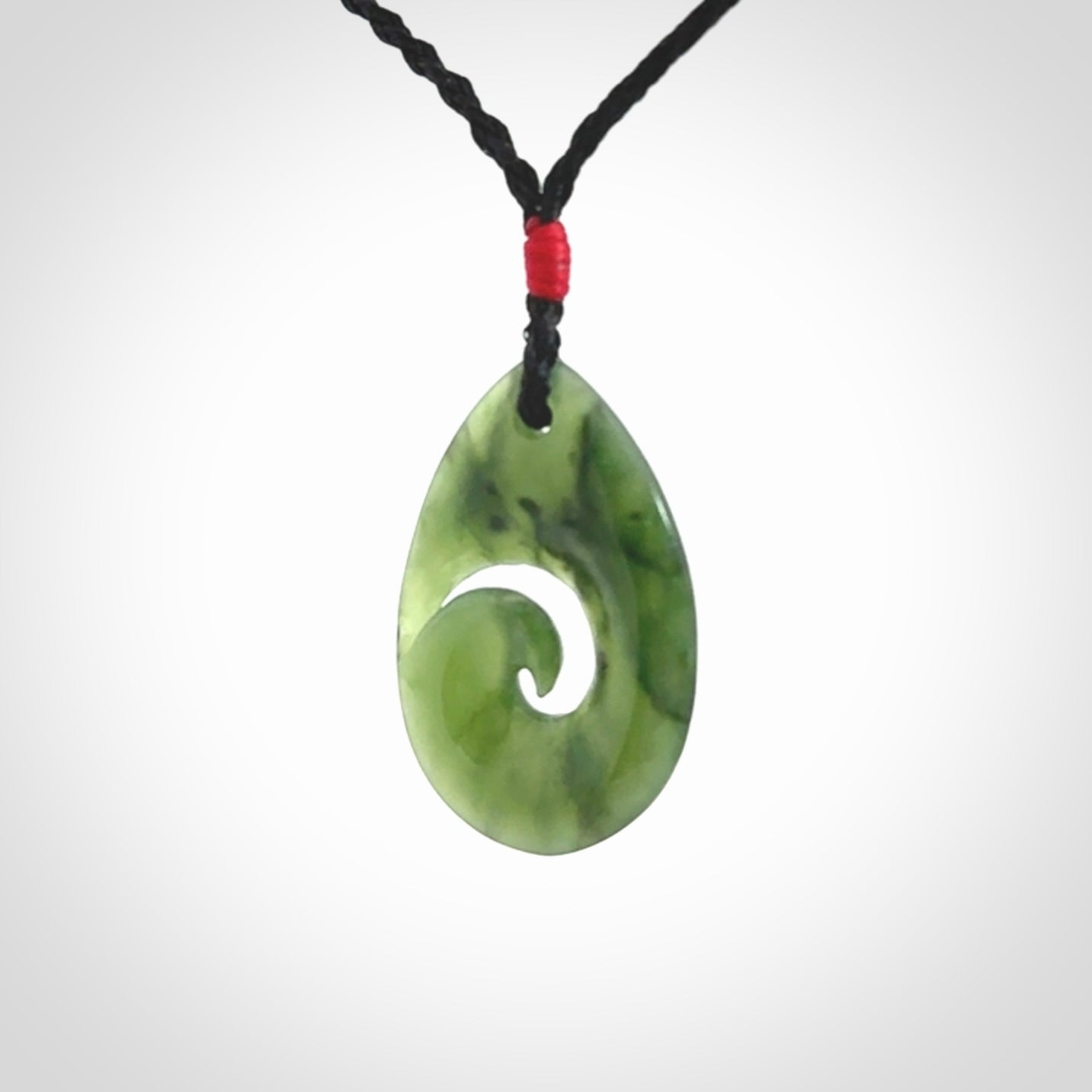 Hand carved New Zealand jade koru drop pendant. Made by NZ Pacific.Hand carved New Zealand jade koru drop pendant. Made by NZ Pacific.