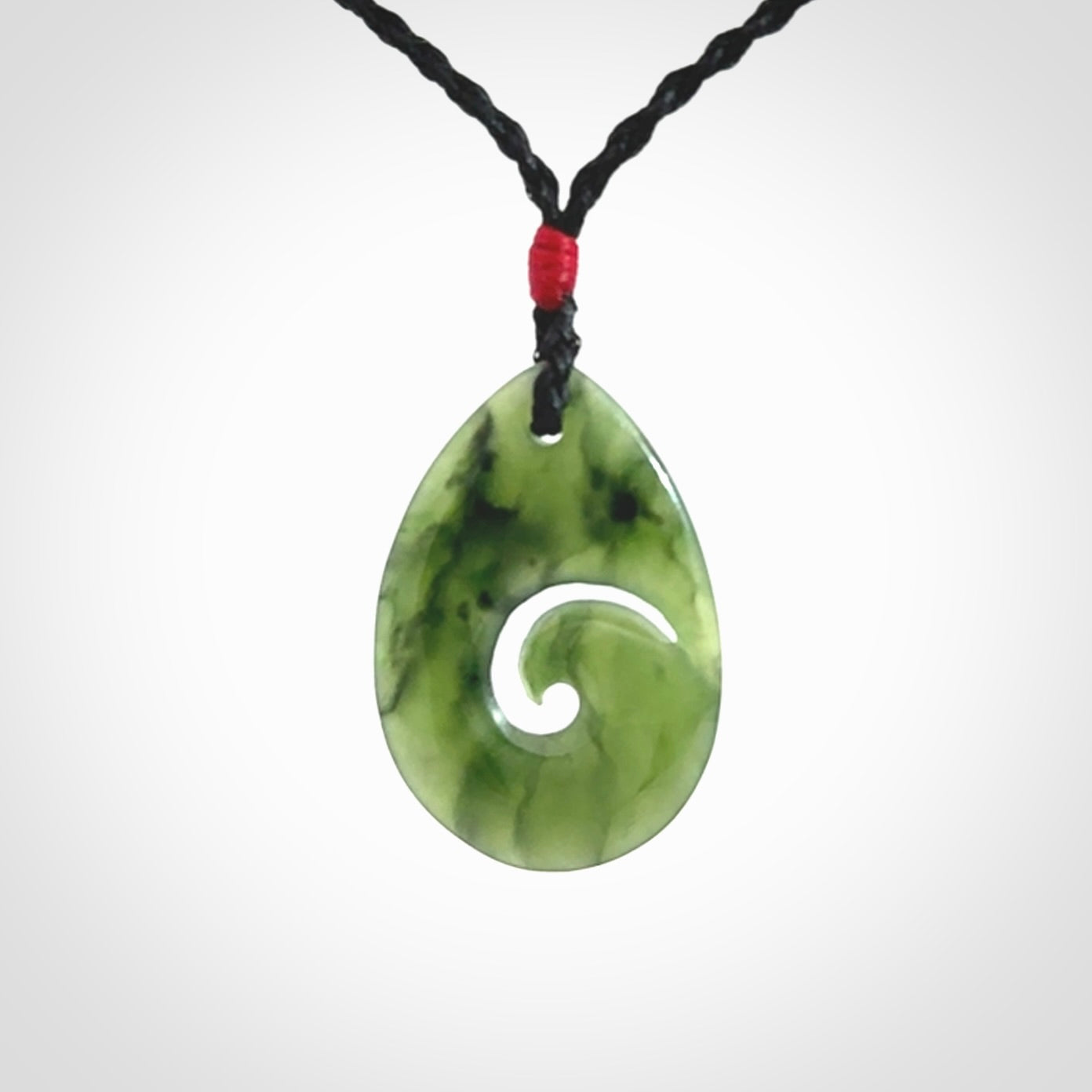 Hand carved New Zealand jade koru drop pendant. Made by NZ Pacific.Hand carved New Zealand jade koru drop pendant. Made by NZ Pacific.