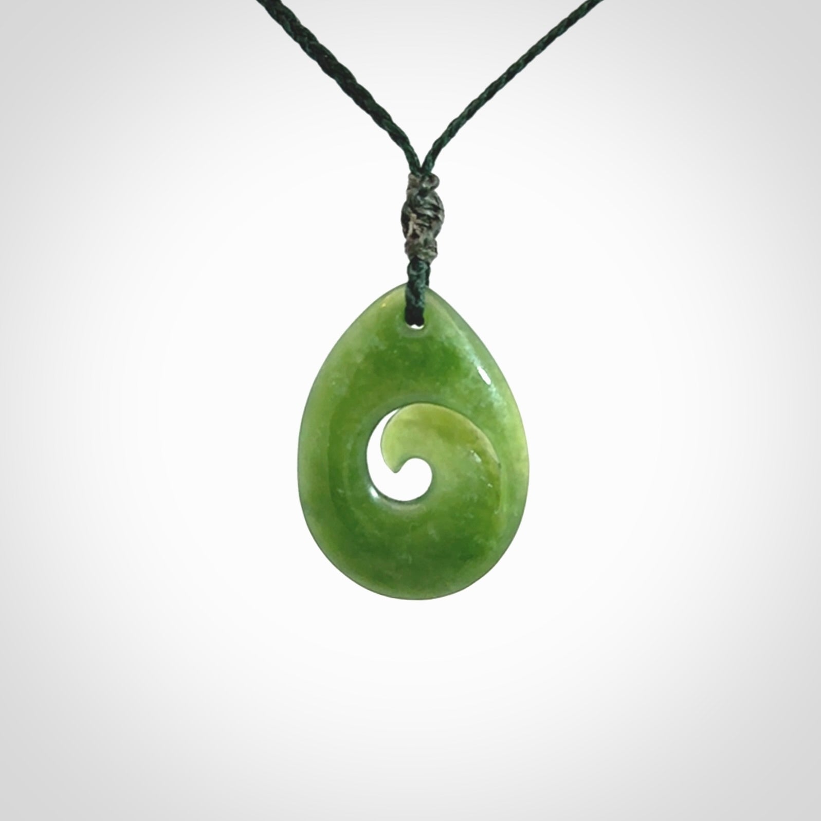 Hand carved New Zealand jade koru drop pendant. Made by NZ Pacific.Hand carved New Zealand jade koru drop pendant. Made by NZ Pacific.