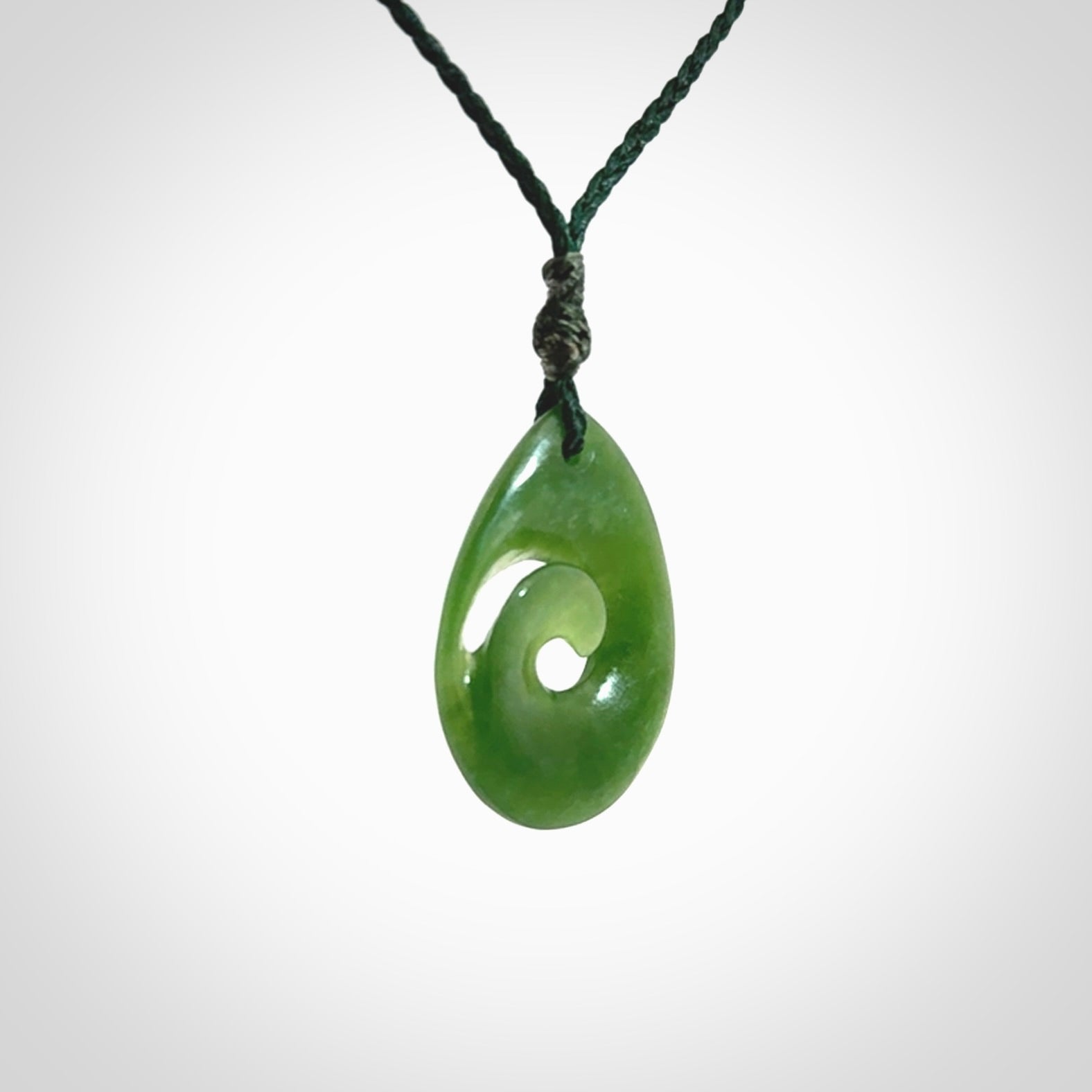 Hand carved New Zealand jade koru drop pendant. Made by NZ Pacific.Hand carved New Zealand jade koru drop pendant. Made by NZ Pacific.