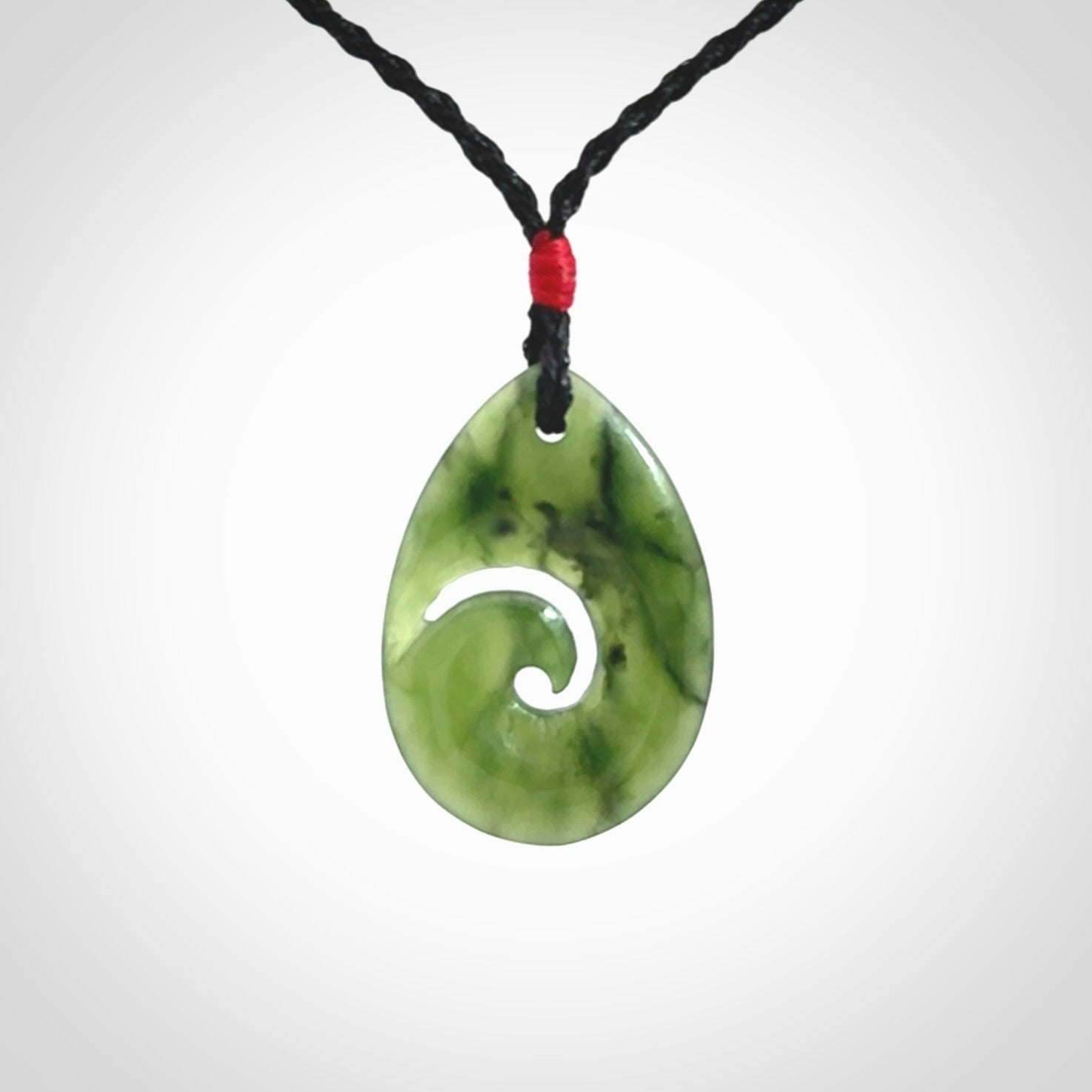Hand carved New Zealand jade koru drop pendant. Made by NZ Pacific.Hand carved New Zealand jade koru drop pendant. Made by NZ Pacific.