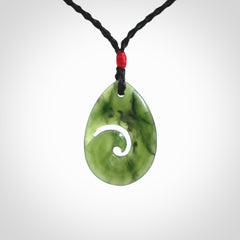 Hand carved New Zealand jade koru drop pendant. Made by NZ Pacific.Hand carved New Zealand jade koru drop pendant. Made by NZ Pacific.