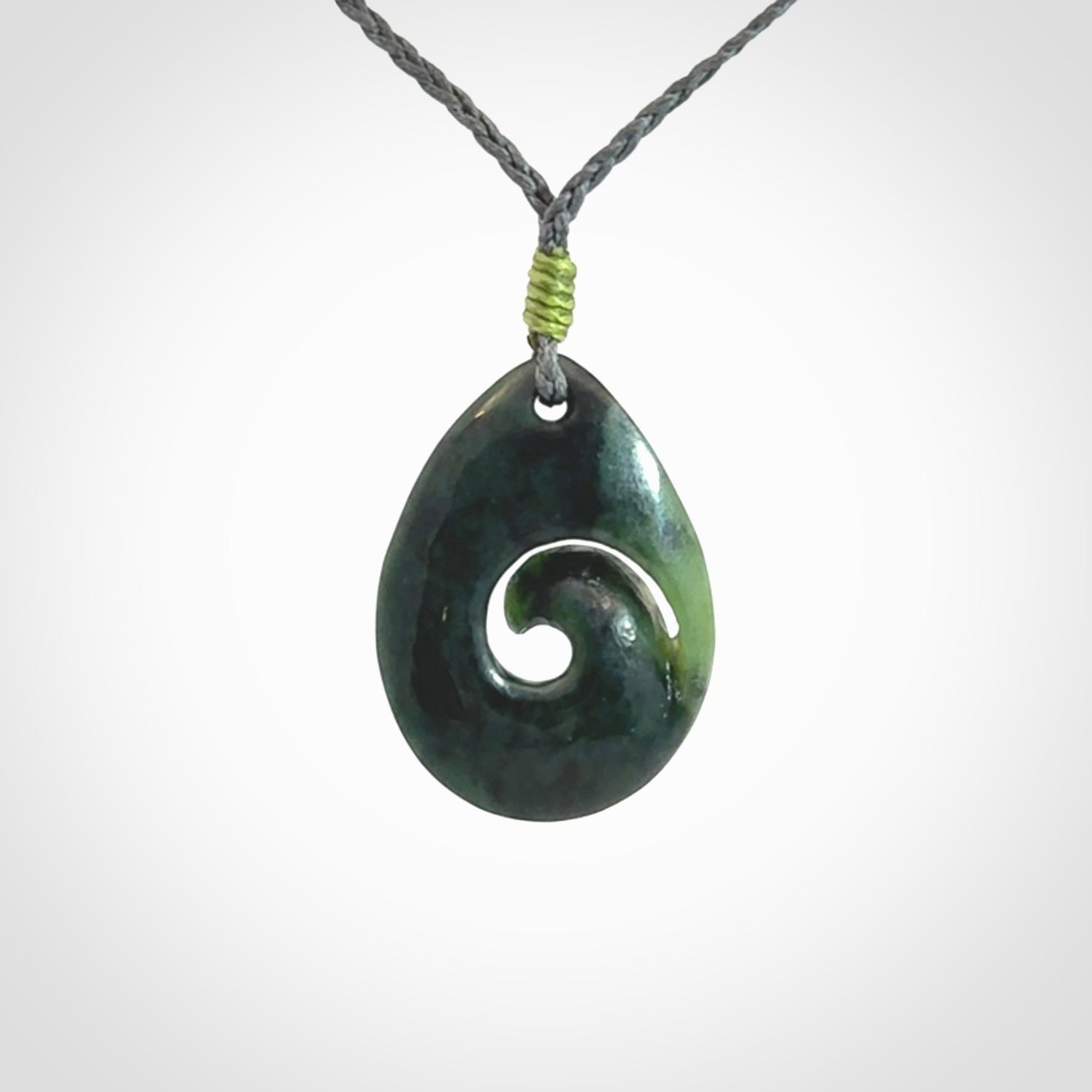 Hand carved New Zealand jade koru drop pendant. Made by NZ Pacific.Hand carved New Zealand jade koru drop pendant. Made by NZ Pacific.