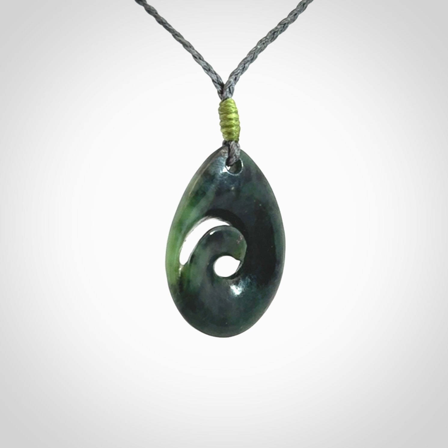Hand carved New Zealand jade koru drop pendant. Made by NZ Pacific.Hand carved New Zealand jade koru drop pendant. Made by NZ Pacific.