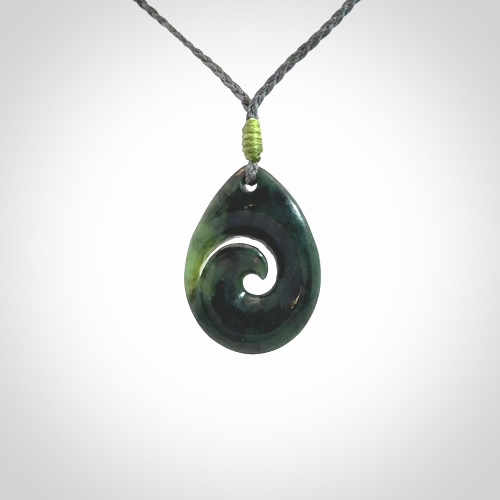 Hand carved New Zealand jade koru drop pendant. Made by NZ Pacific.Hand carved New Zealand jade koru drop pendant. Made by NZ Pacific.