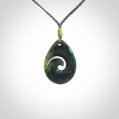 Hand carved New Zealand jade koru drop pendant. Made by NZ Pacific.Hand carved New Zealand jade koru drop pendant. Made by NZ Pacific.