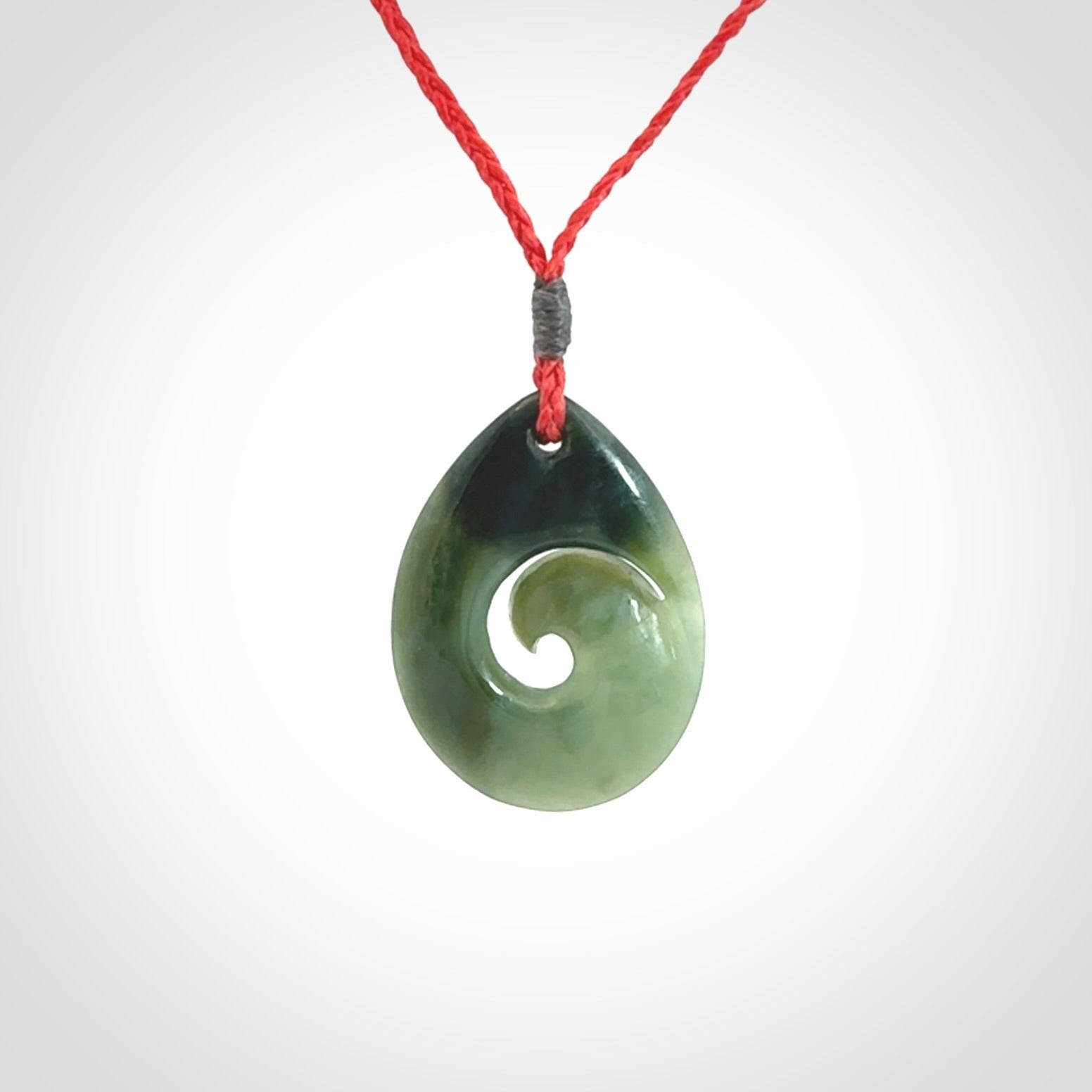 Hand carved New Zealand jade koru drop pendant. Made by NZ Pacific.Hand carved New Zealand jade koru drop pendant. Made by NZ Pacific.