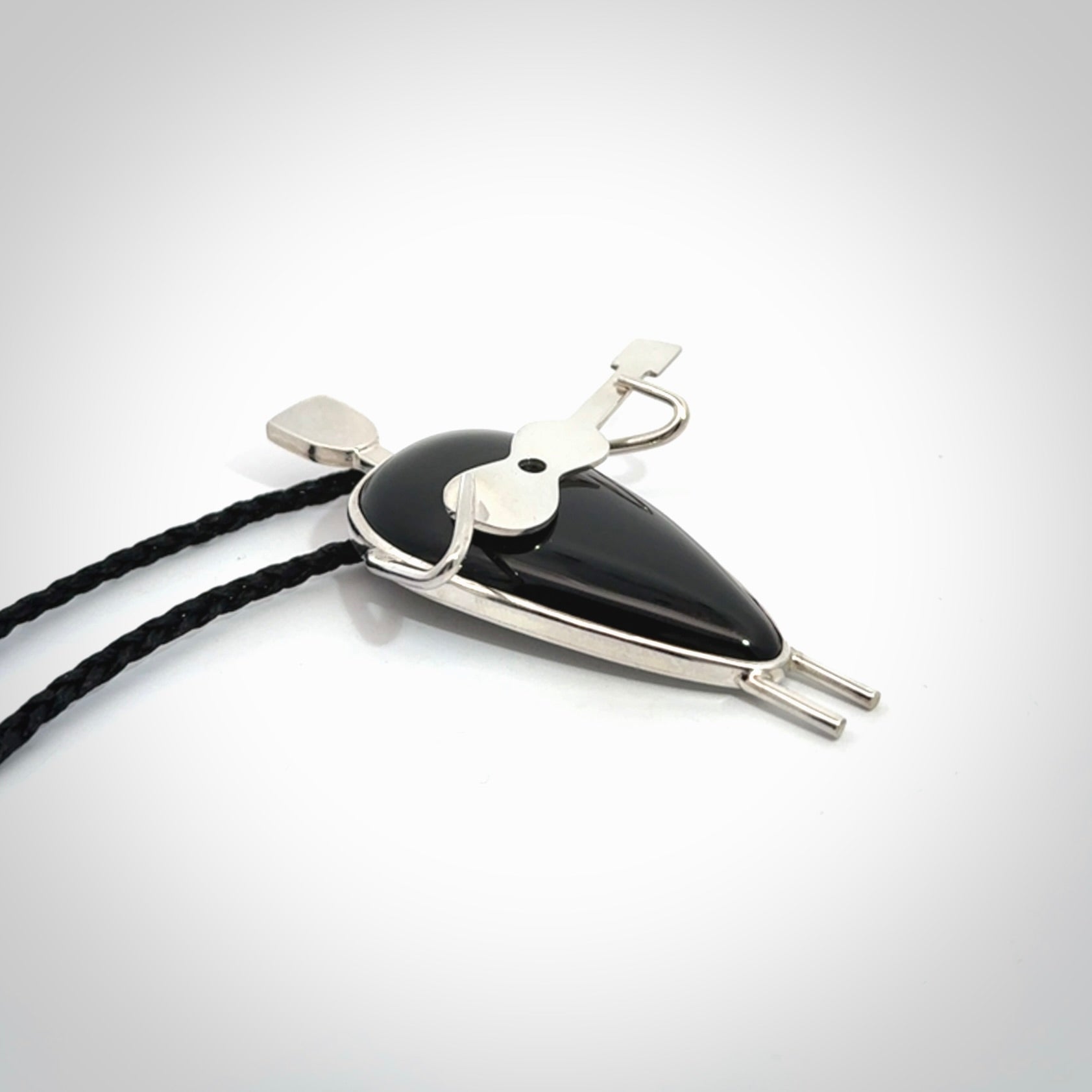 This is a very cool and creative guitarist hand made from Australian Black Jade and Sterling Silver. A guitar playing person hand crafted from sterling silver with Black Jade torso. A spectacular piece of art to wear.