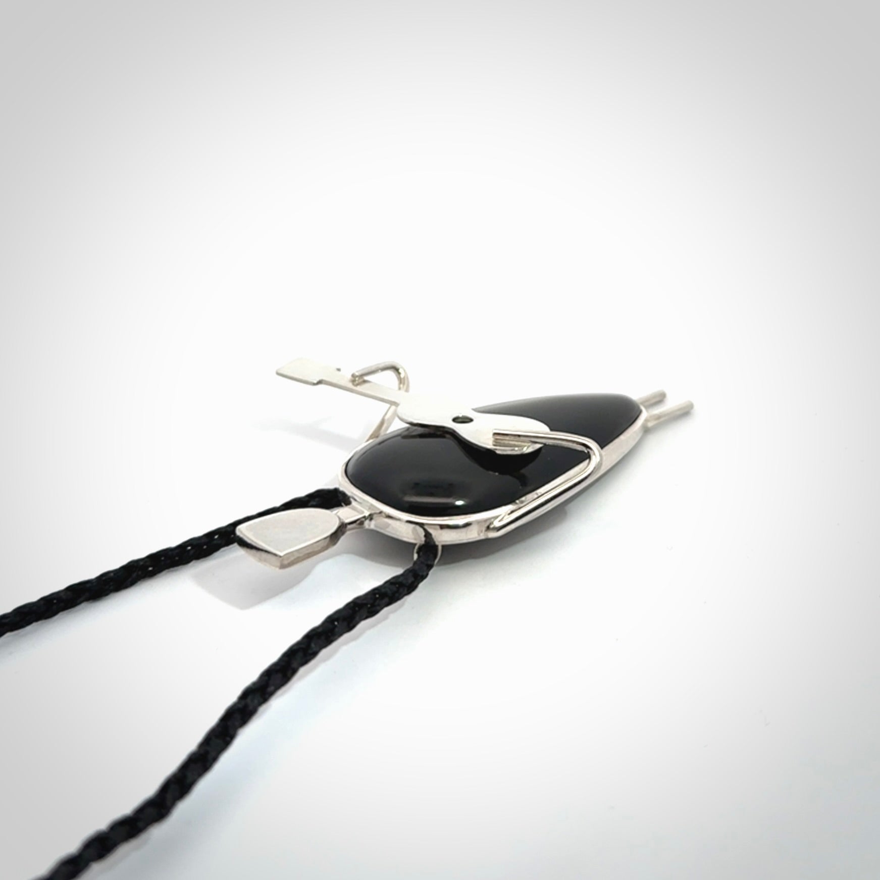 This is a very cool and creative guitarist hand made from Australian Black Jade and Sterling Silver. A guitar playing person hand crafted from sterling silver with Black Jade torso. A spectacular piece of art to wear.