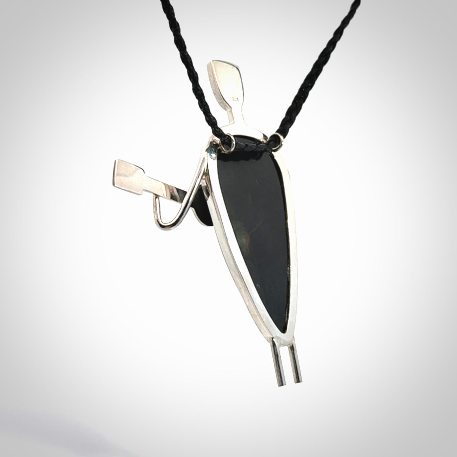 This is a very cool and creative guitarist hand made from Australian Black Jade and Sterling Silver. A guitar playing person hand crafted from sterling silver with Black Jade torso. A spectacular piece of art to wear.