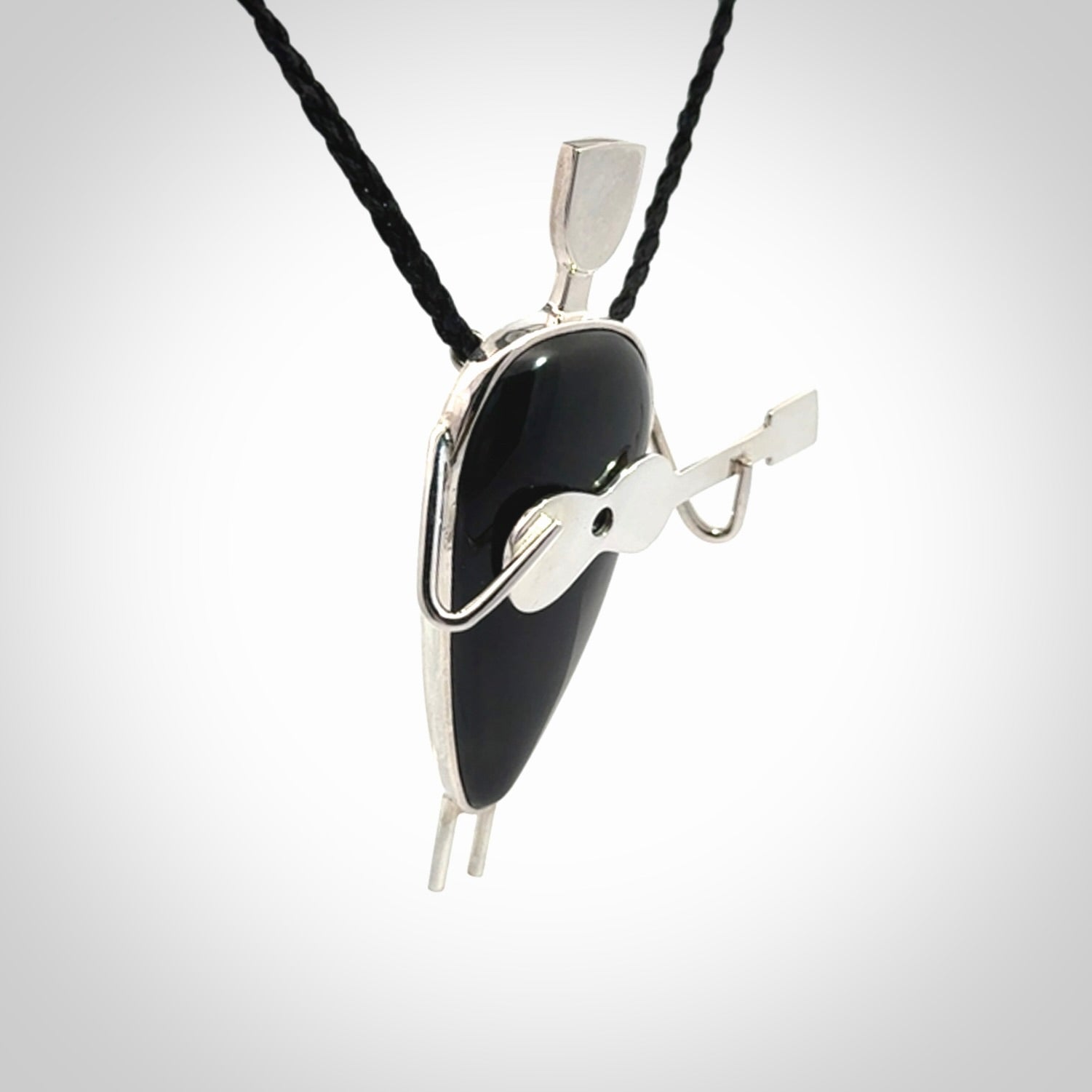 This is a very cool and creative guitarist hand made from Australian Black Jade and Sterling Silver. A guitar playing person hand crafted from sterling silver with Black Jade torso. A spectacular piece of art to wear.