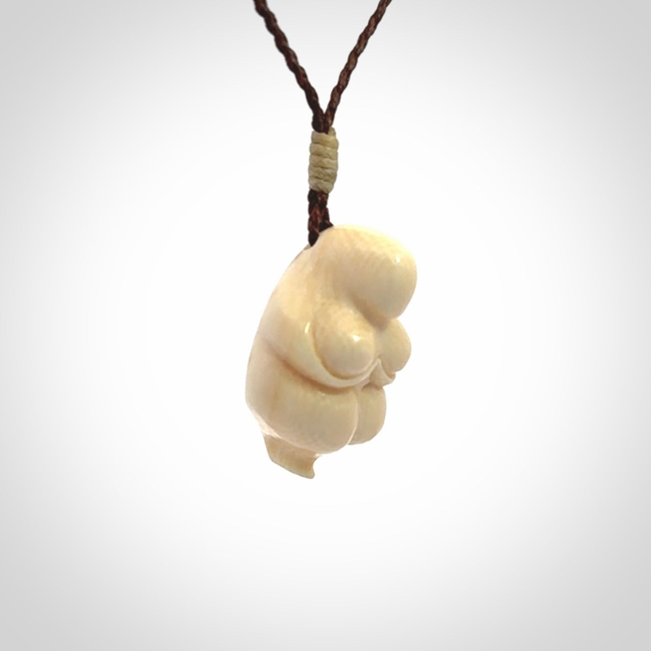Hand carved mammoth tusk goddess pendant. Hand carved Mammoth Tusk jewellery for sale online by NZ Pacific. Delivered with a fine adjustable cord and packaged in a woven kete pouch.