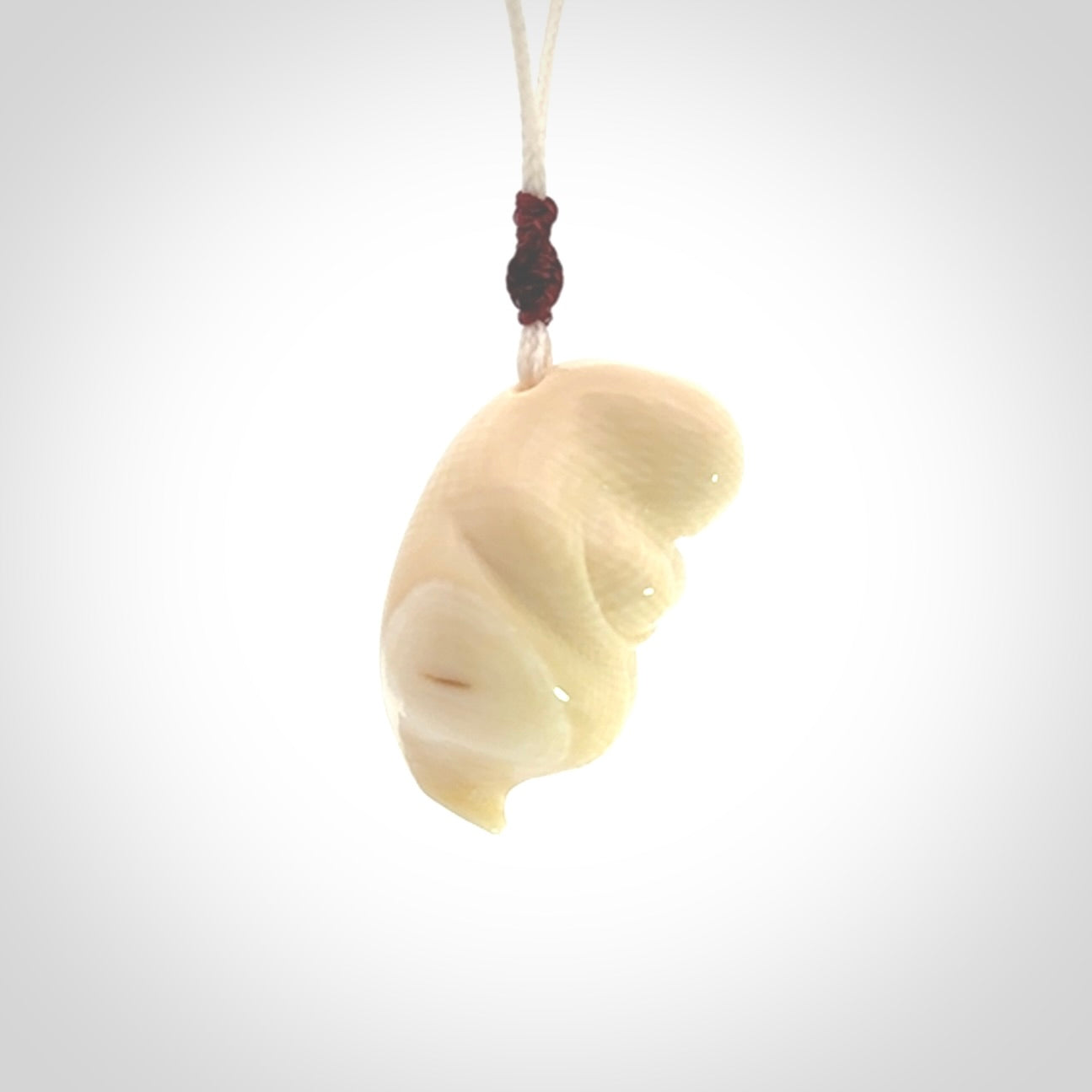 Hand carved mammoth tusk goddess pendant. Hand carved Mammoth Tusk jewellery for sale online by NZ Pacific. Delivered with a fine adjustable cord and packaged in a woven kete pouch.