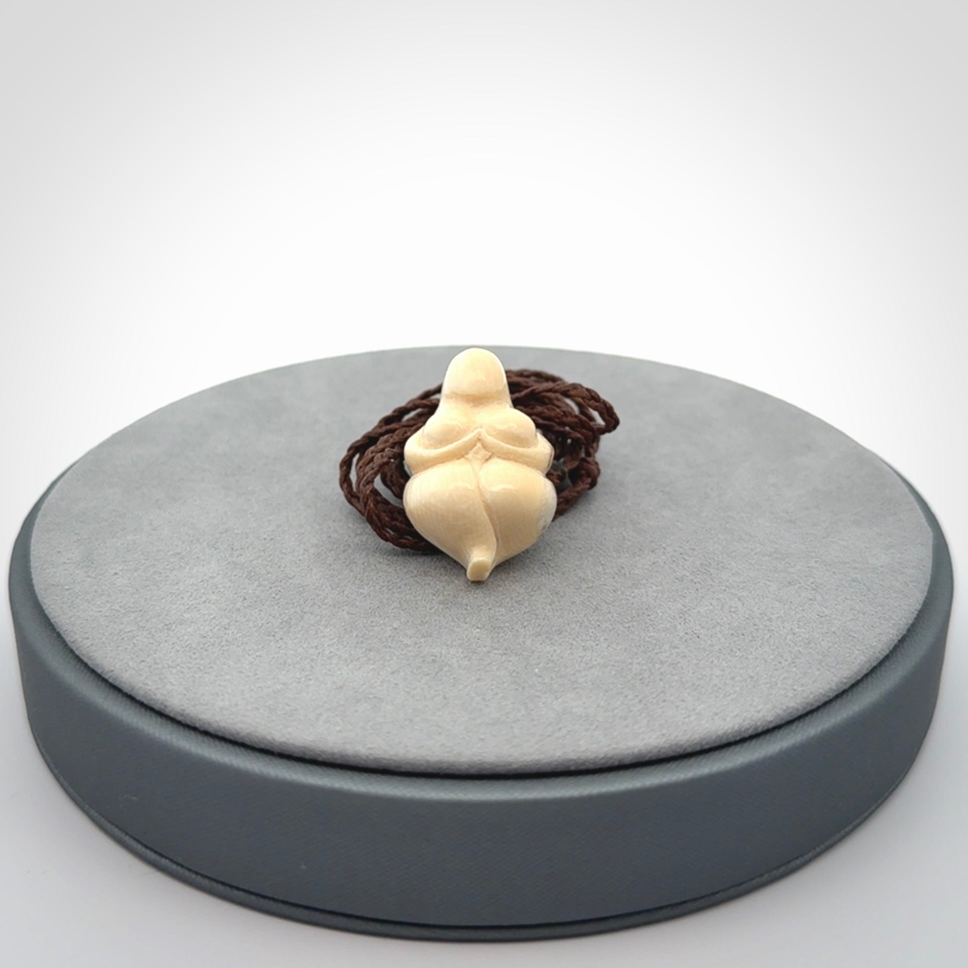 Hand carved mammoth tusk goddess pendant. Hand carved Mammoth Tusk jewellery for sale online by NZ Pacific. Delivered with a fine adjustable cord and packaged in a woven kete pouch.