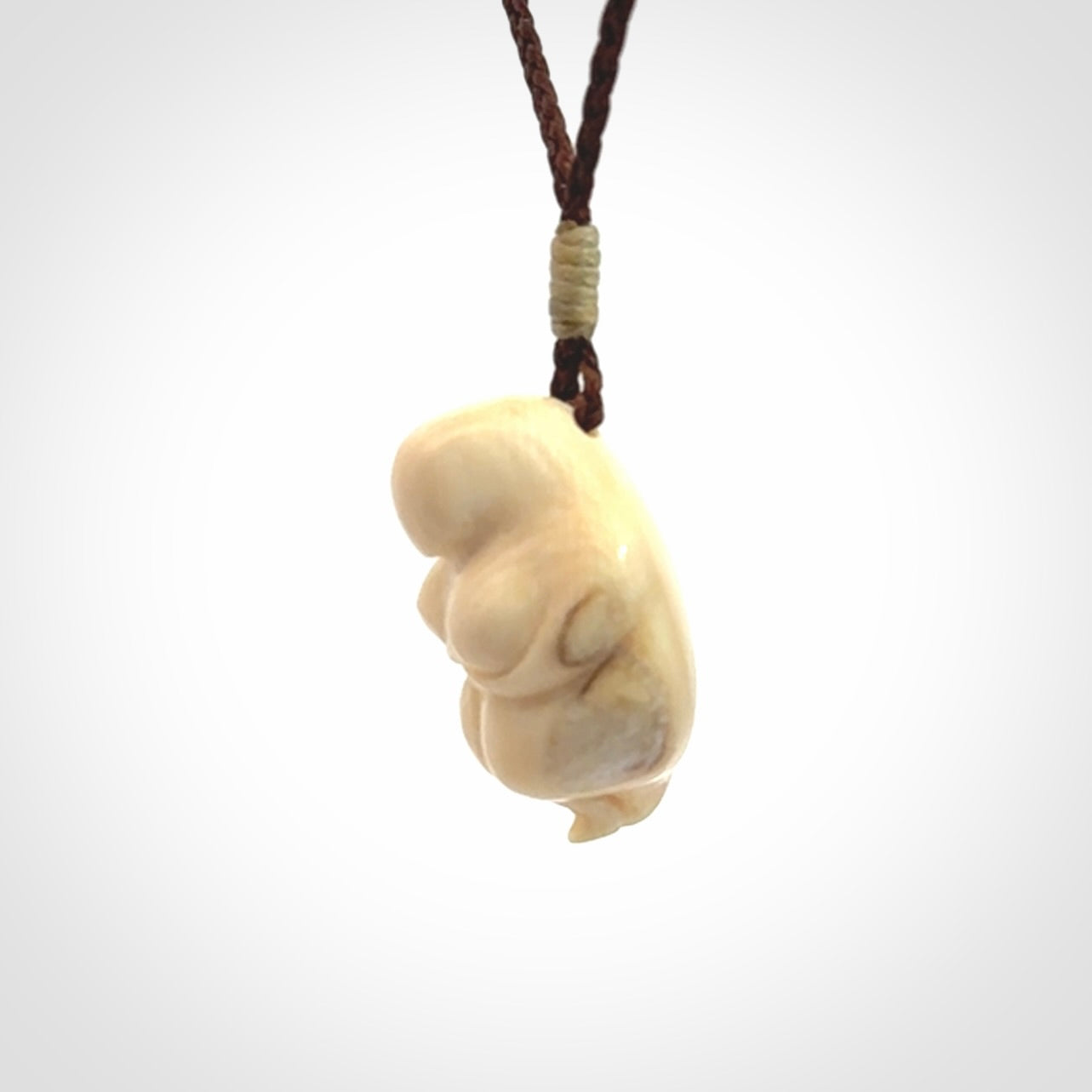 Hand carved mammoth tusk goddess pendant. Hand carved Mammoth Tusk jewellery for sale online by NZ Pacific. Delivered with a fine adjustable cord and packaged in a woven kete pouch.