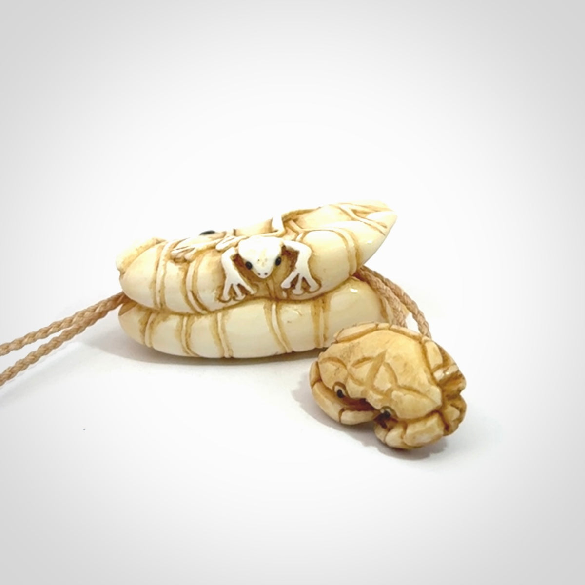 Hand carved bone frog on lotus leaf with moving crab pendant. Made from Bone in New Zealand. Made by master bone carver Fumio Noguchi. Spectacular collectable work of art, made to wear. One only pendant, delivered to you with express courier on a beige adjustable cord.