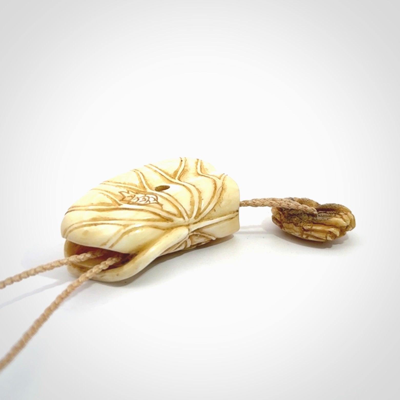Hand carved bone frog on lotus leaf with moving crab pendant. Made from Bone in New Zealand. Made by master bone carver Fumio Noguchi. Spectacular collectable work of art, made to wear. One only pendant, delivered to you with express courier on a beige adjustable cord.