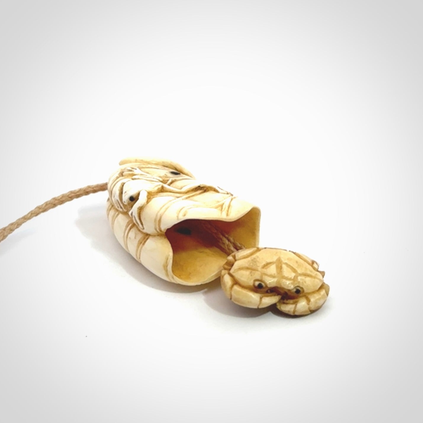 Hand carved bone frog on lotus leaf with moving crab pendant. Made from Bone in New Zealand. Made by master bone carver Fumio Noguchi. Spectacular collectable work of art, made to wear. One only pendant, delivered to you with express courier on a beige adjustable cord.