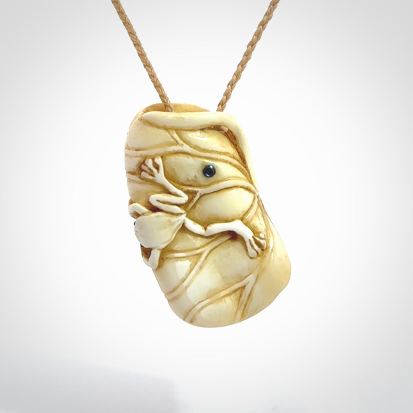 Hand carved bone frog on lotus leaf with moving crab pendant. Made from Bone in New Zealand. Made by master bone carver Fumio Noguchi. Spectacular collectable work of art, made to wear. One only pendant, delivered to you with express courier on a beige adjustable cord.