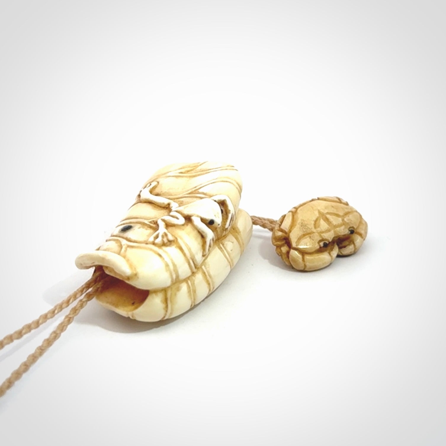 Hand carved bone frog on lotus leaf with moving crab pendant. Made from Bone in New Zealand. Made by master bone carver Fumio Noguchi. Spectacular collectable work of art, made to wear. One only pendant, delivered to you with express courier on a beige adjustable cord.
