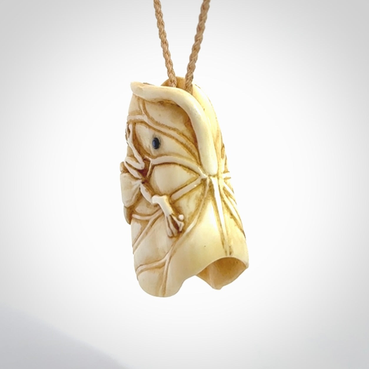 Hand carved bone frog on lotus leaf with moving crab pendant. Made from Bone in New Zealand. Made by master bone carver Fumio Noguchi. Spectacular collectable work of art, made to wear. One only pendant, delivered to you with express courier on a beige adjustable cord.