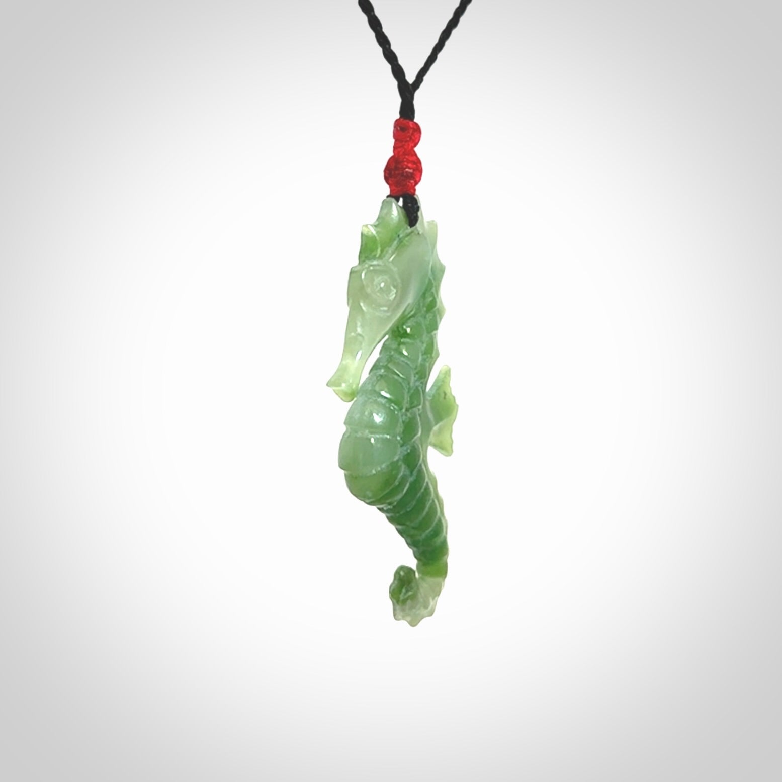 A hand carved seahorse pendant. We have carved this from beautiful nephrite jade and we bind them with our hand-plaited cords. We ship these worldwide with express courier anywhere in the world.