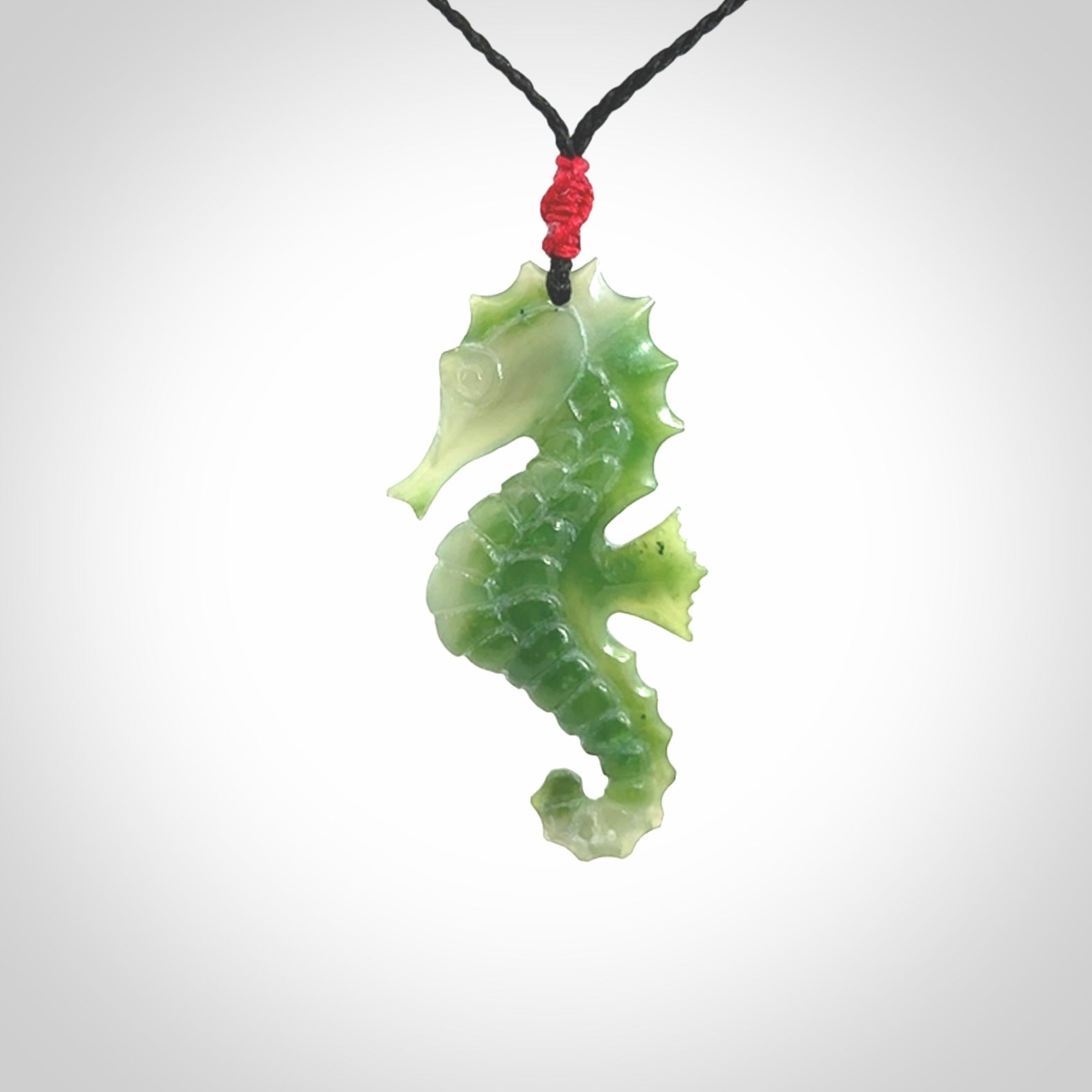 A hand carved seahorse pendant. We have carved this from beautiful nephrite jade and we bind them with our hand-plaited cords. We ship these worldwide with express courier anywhere in the world.