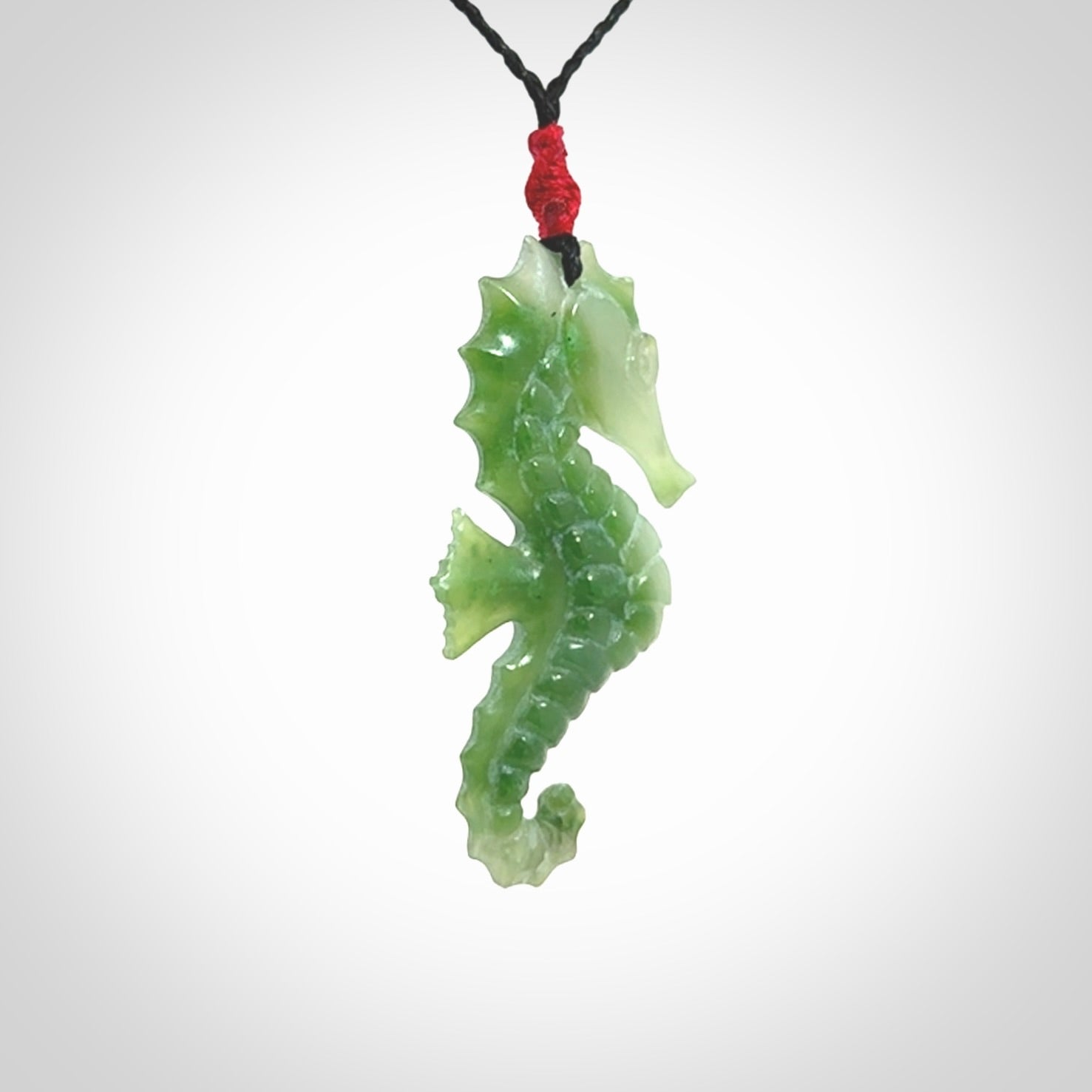 A hand carved seahorse pendant. We have carved this from beautiful nephrite jade and we bind them with our hand-plaited cords. We ship these worldwide with express courier anywhere in the world.