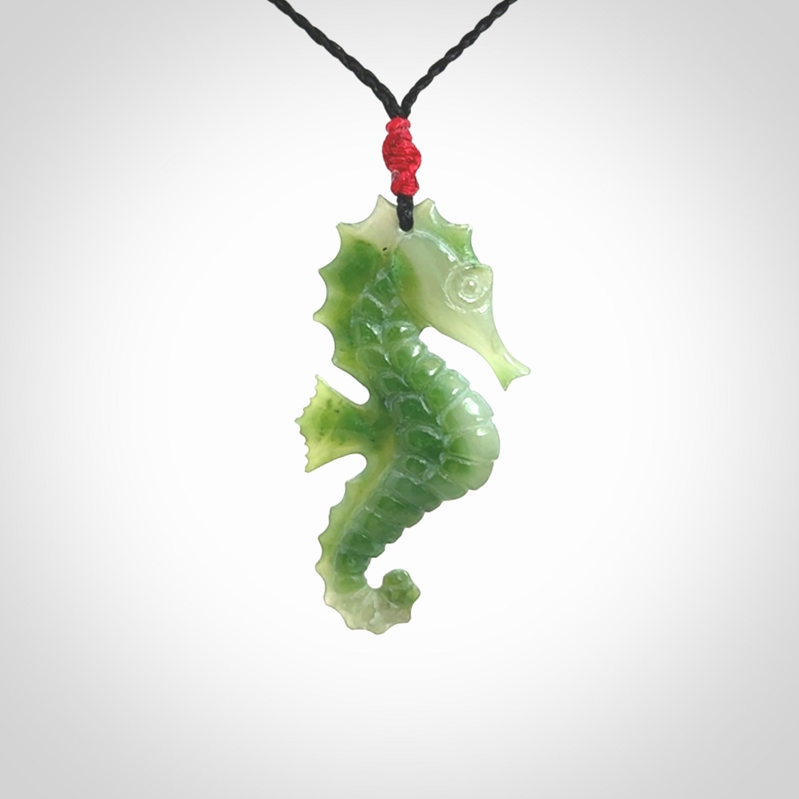 A hand carved seahorse pendant. We have carved this from beautiful nephrite jade and we bind them with our hand-plaited cords. We ship these worldwide with express courier anywhere in the world.