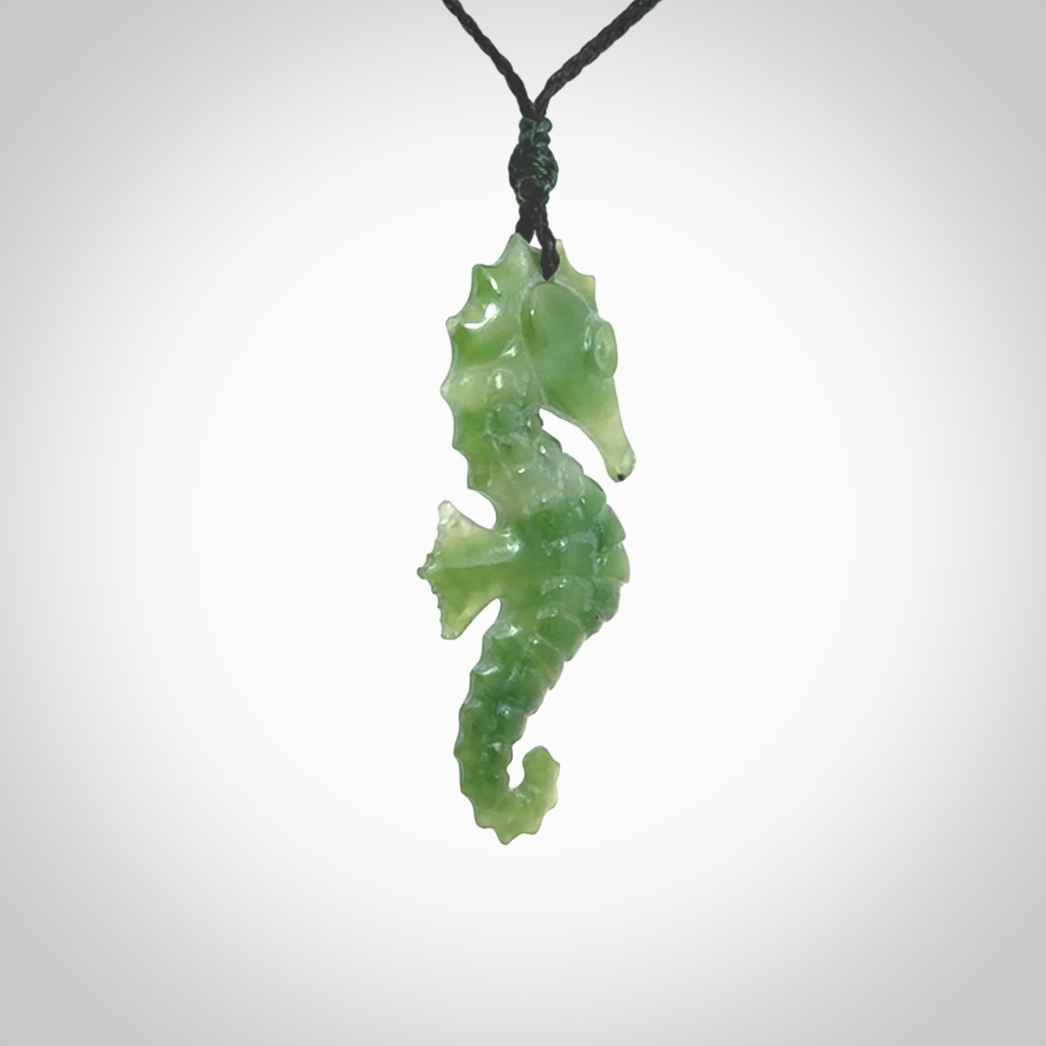 A hand carved seahorse pendant. We have carved this from beautiful nephrite jade and we bind them with our hand-plaited cords. the cords are a waxed polyester so they are durable and strong. We ship these worldwide with express courier anywhere in the world.