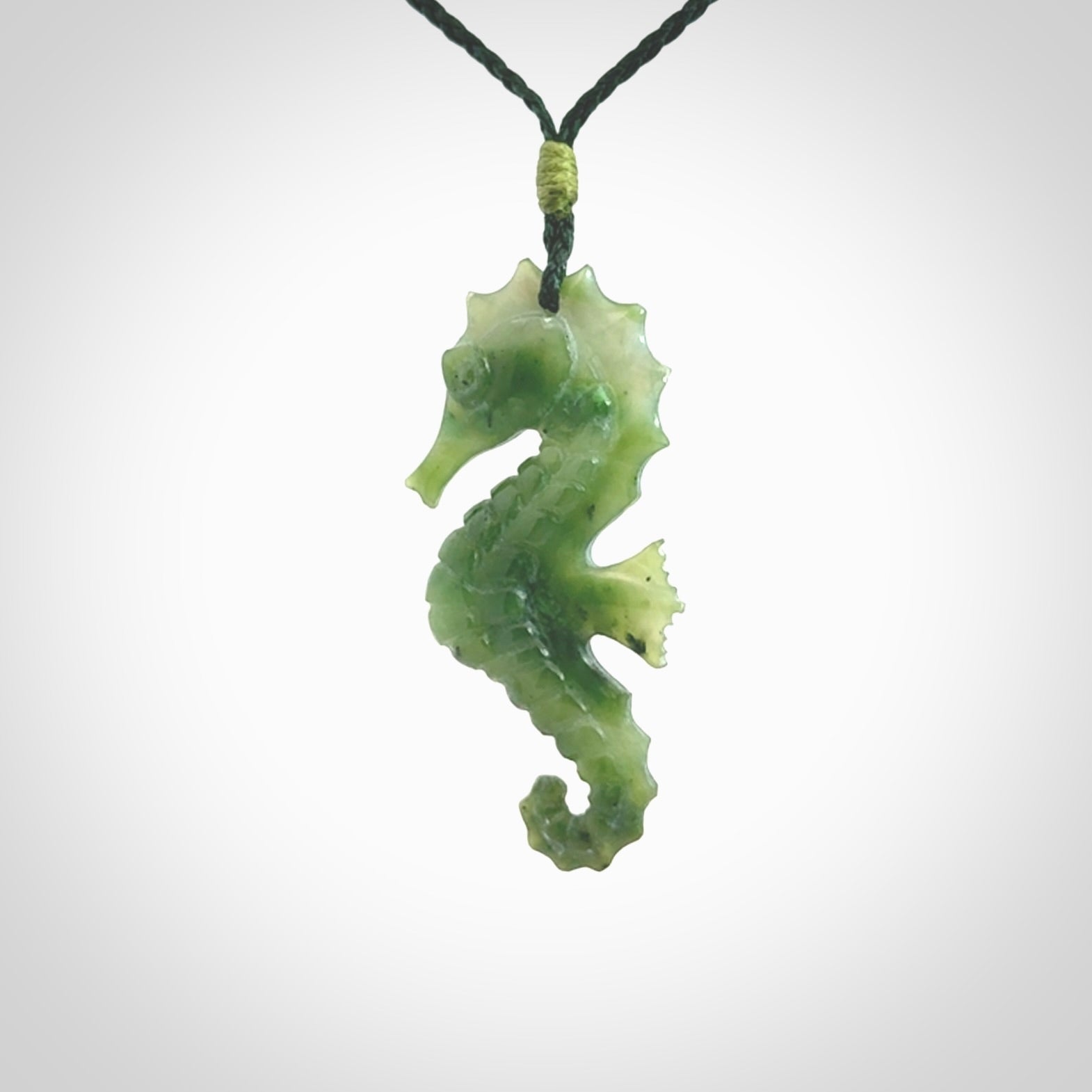 A hand carved seahorse pendant. We have carved this from beautiful nephrite jade and we bind them with our hand-plaited cords. We ship these worldwide with express courier anywhere in the world.