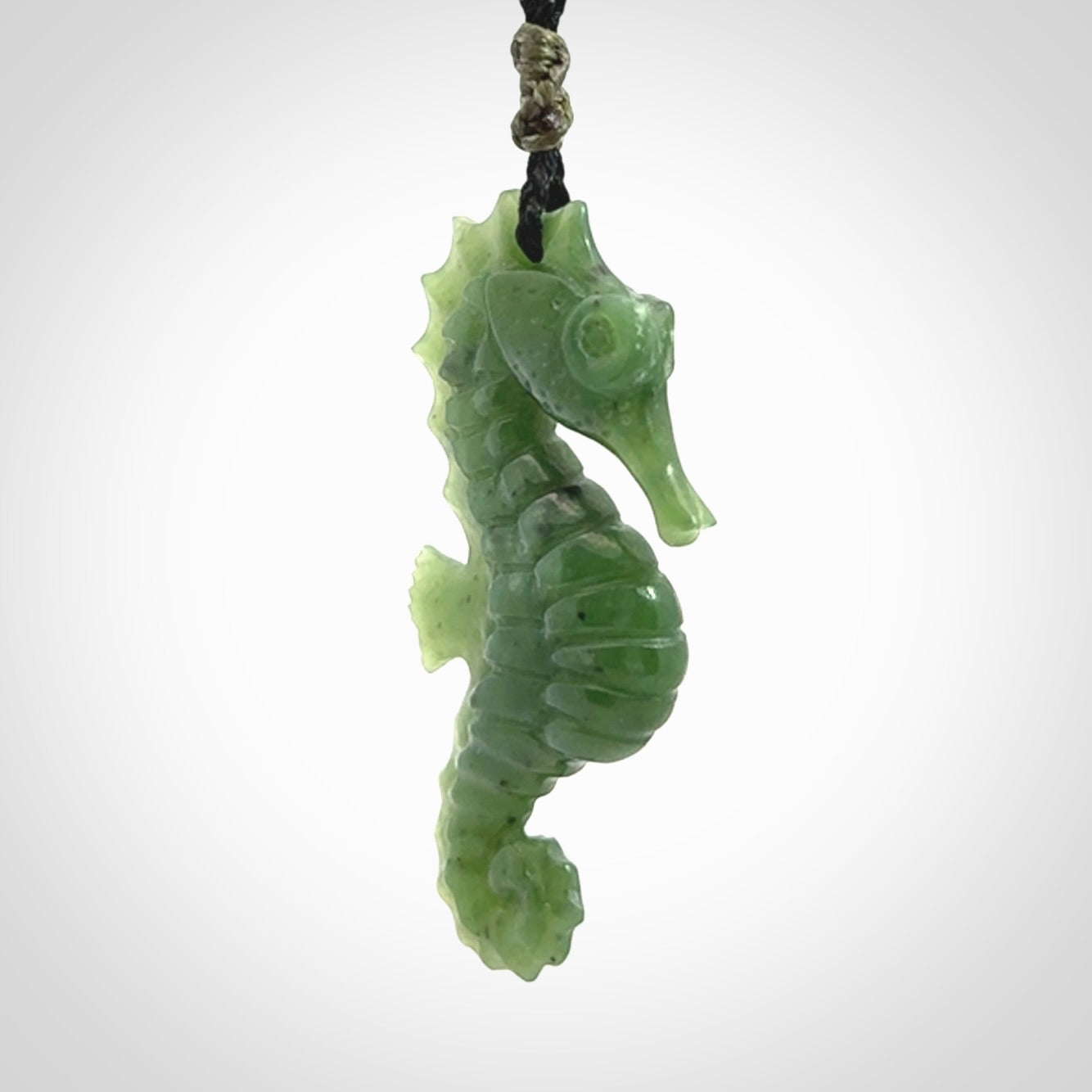 A hand carved seahorse pendant. We have carved this from beautiful nephrite jade and we bind them with our hand-plaited cords. We ship these worldwide with express courier anywhere in the world.