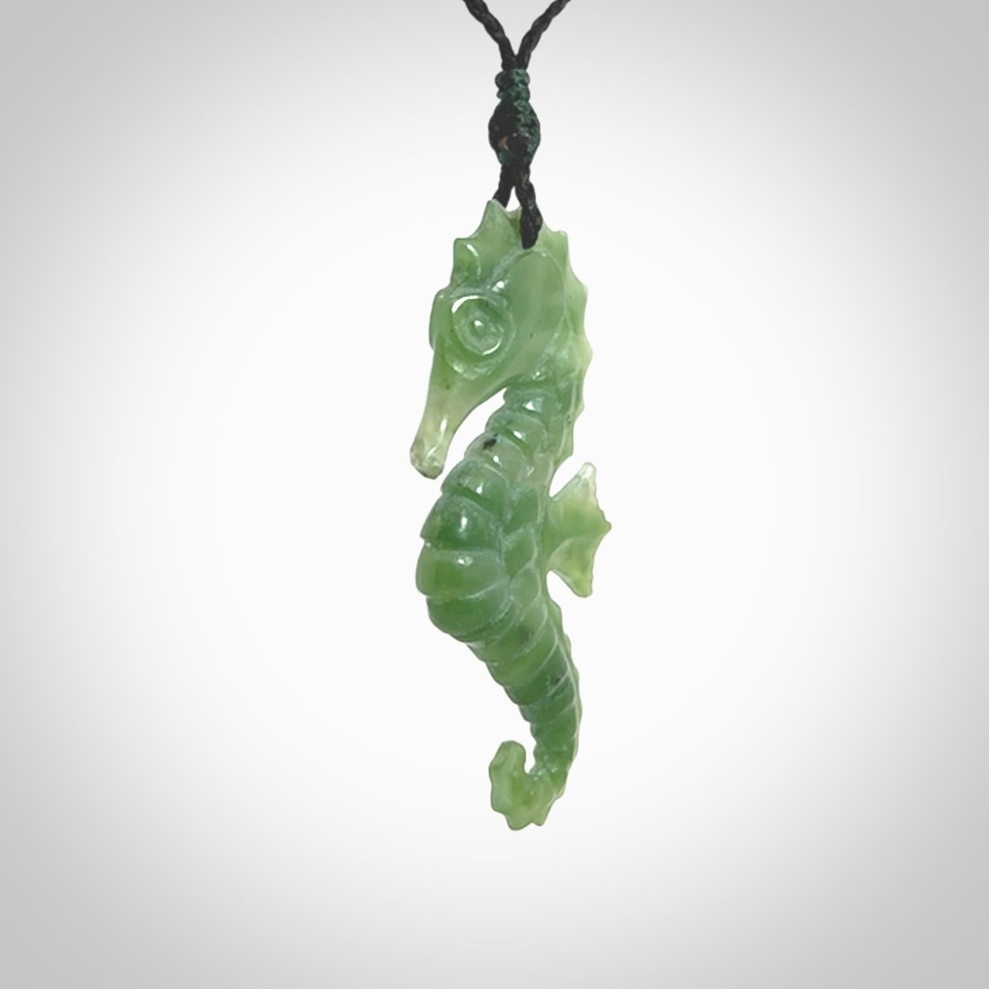 A hand carved seahorse pendant. We have carved this from beautiful nephrite jade and we bind them with our hand-plaited cords. the cords are a waxed polyester so they are durable and strong. We ship these worldwide with express courier anywhere in the world.