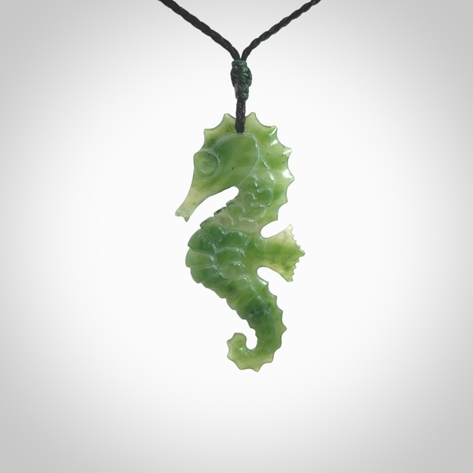 A hand carved seahorse pendant. We have carved this from beautiful nephrite jade and we bind them with our hand-plaited cords. the cords are a waxed polyester so they are durable and strong. We ship these worldwide with express courier anywhere in the world.