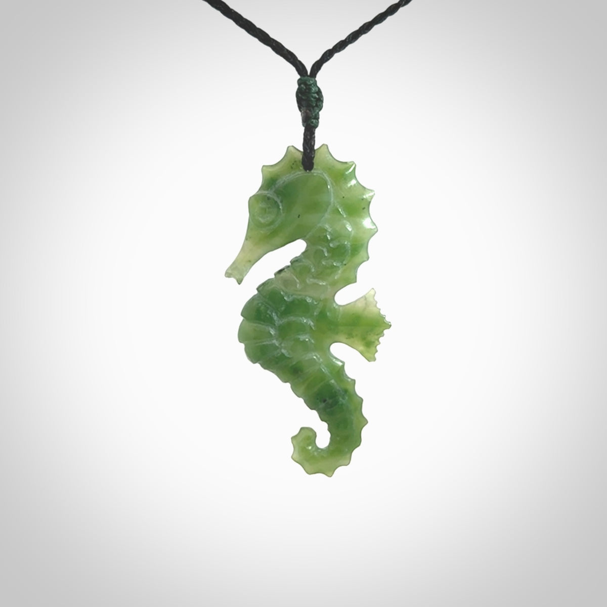 A hand carved seahorse pendant. We have carved this from beautiful nephrite jade and we bind them with our hand-plaited cords. the cords are a waxed polyester so they are durable and strong. We ship these worldwide with express courier anywhere in the world.