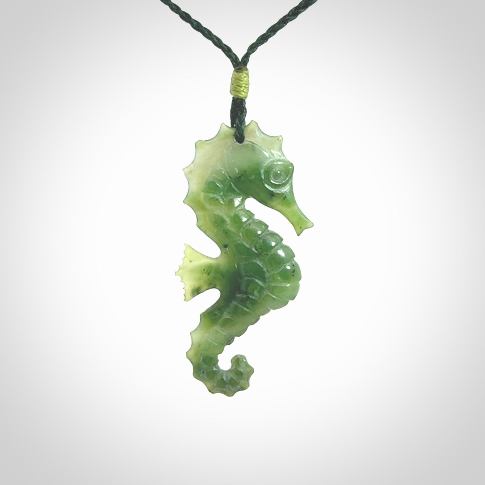 A hand carved seahorse pendant. We have carved this from beautiful nephrite jade and we bind them with our hand-plaited cords. We ship these worldwide with express courier anywhere in the world.